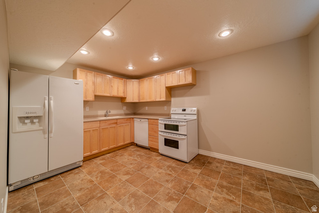 598 Hollow Creek Road Draper, UT 84020 - Photo 58 of 110 Kitchen area featuring light wood cabinetry, white appliances, and recessed lighting