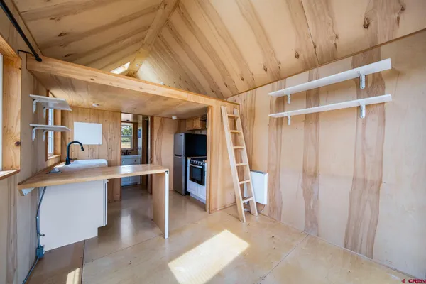 a view of work space with wooden floor and furniture