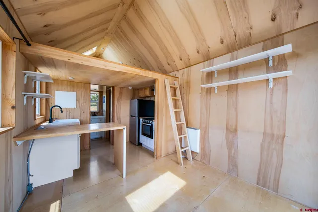 a view of work space with wooden floor and furniture