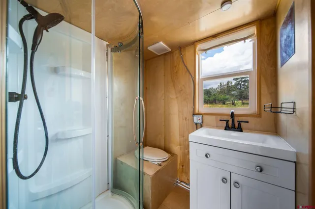 a bathroom with a granite countertop toilet sink and mirror