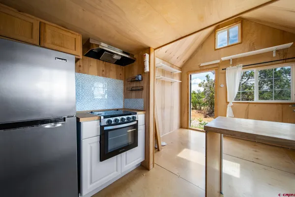 a kitchen with a stove and a refrigerator