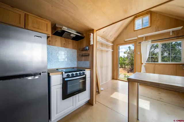 a kitchen with a stove and a refrigerator