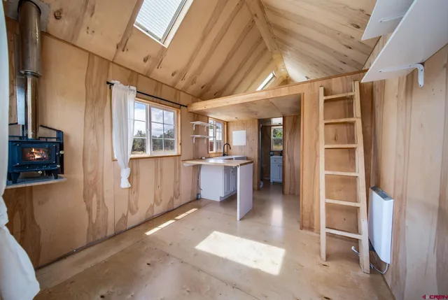 a view of a hallway with furniture and a kitchen