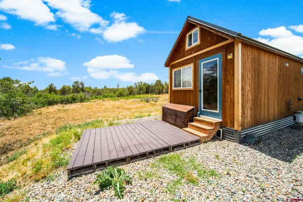 a view of a backyard with sitting area