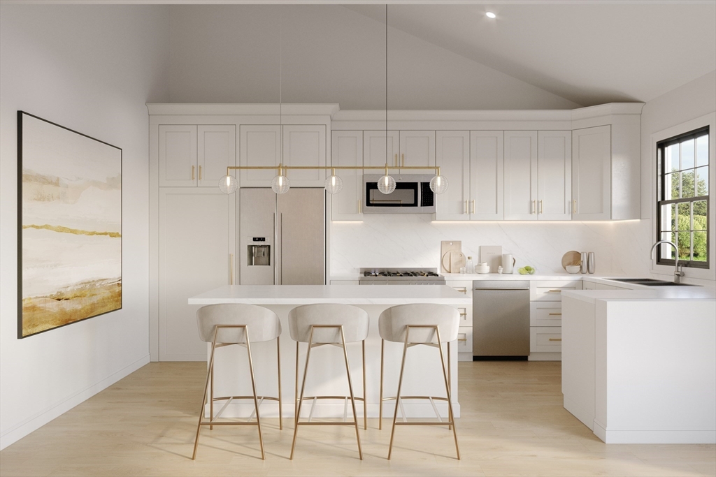 25 Vinal Street, Unit 29 Auburn, MA 01501 - Photo 5 of 7 a kitchen with kitchen island granite countertop white cabinets and white appliances