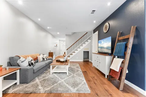a living room with furniture and wooden floor