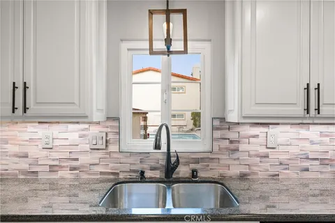 a kitchen with a sink and a window