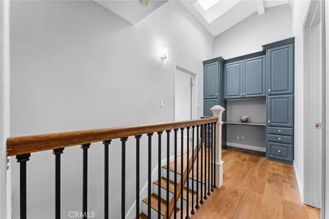 a view of a kitchen with wooden floor and electronic appliances
