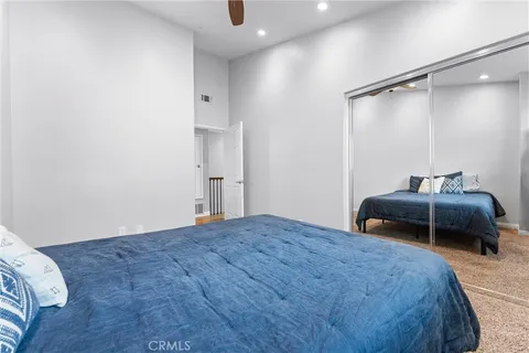 a bedroom with a bed and a mirror