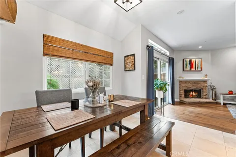 a living room with fireplace furniture and a large window