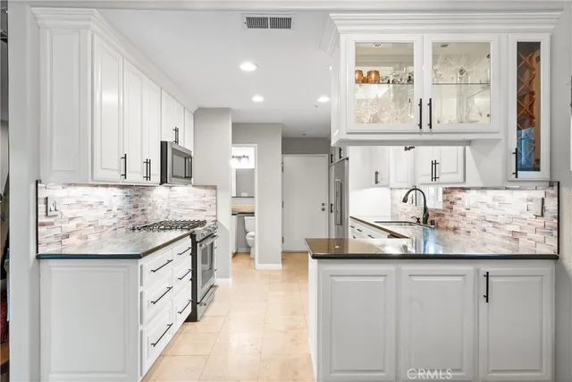 a kitchen with granite countertop a sink and cabinets