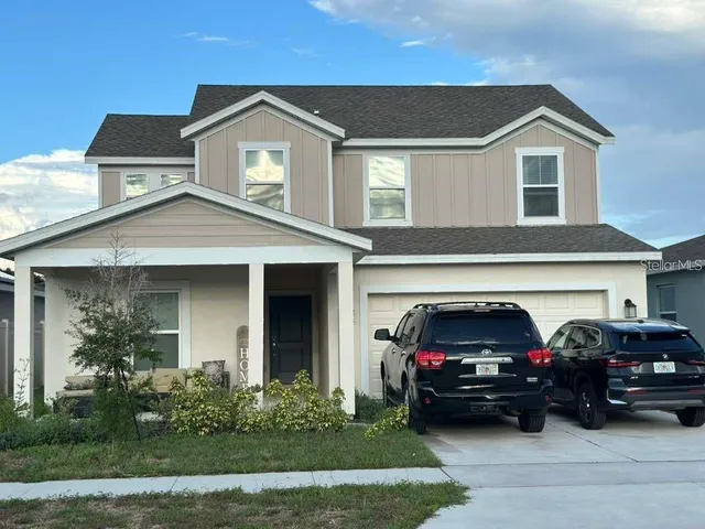 a view of a car parked in front of a house