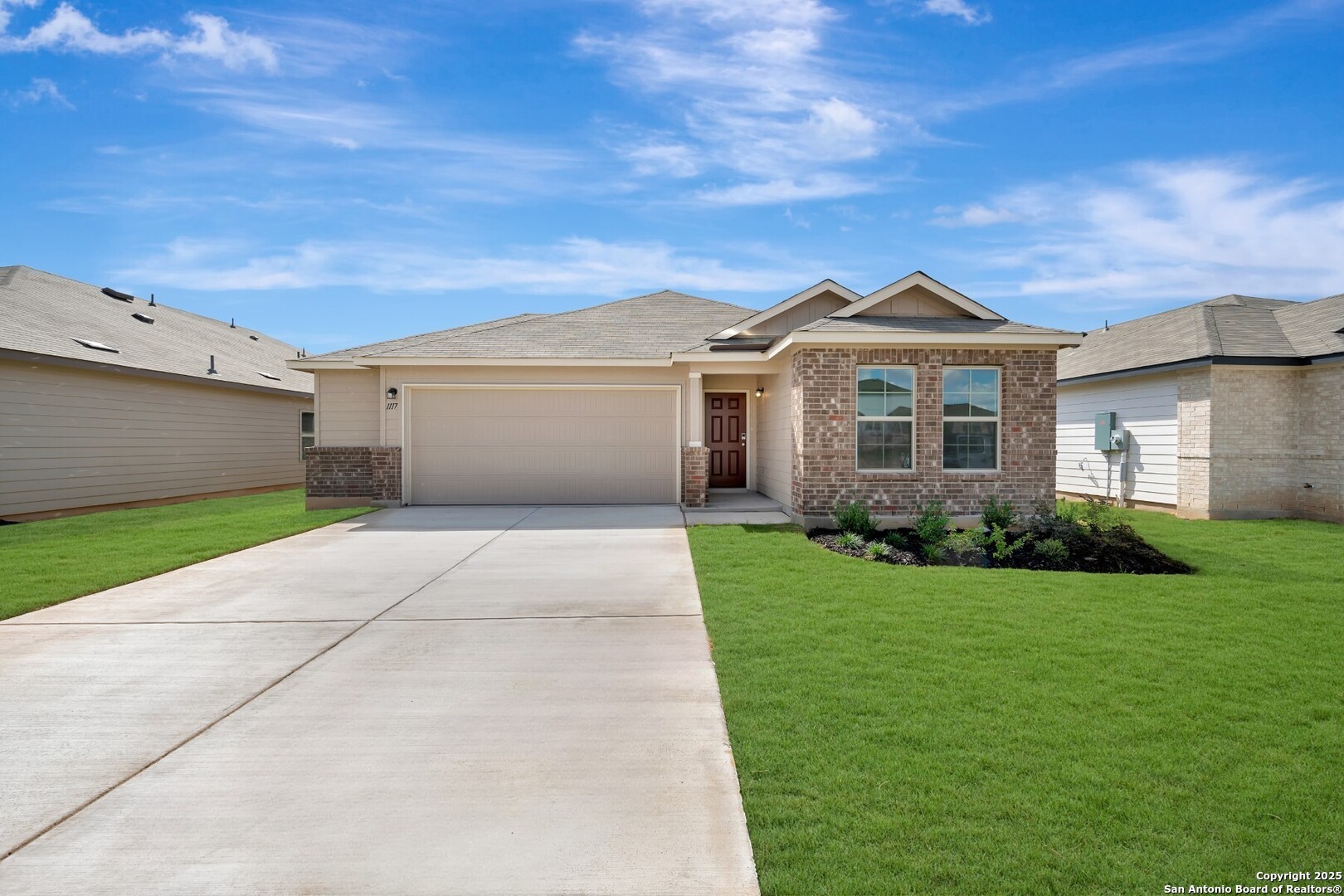 a front view of a house with a garden