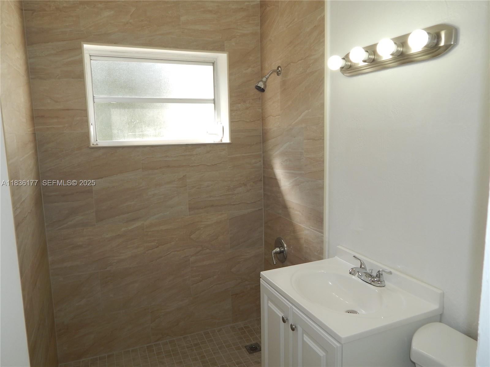 7800 Southwest 69th Avenue Miami, FL 33143 - Photo 17 of 24 a bathroom with a sink toilet and vanity