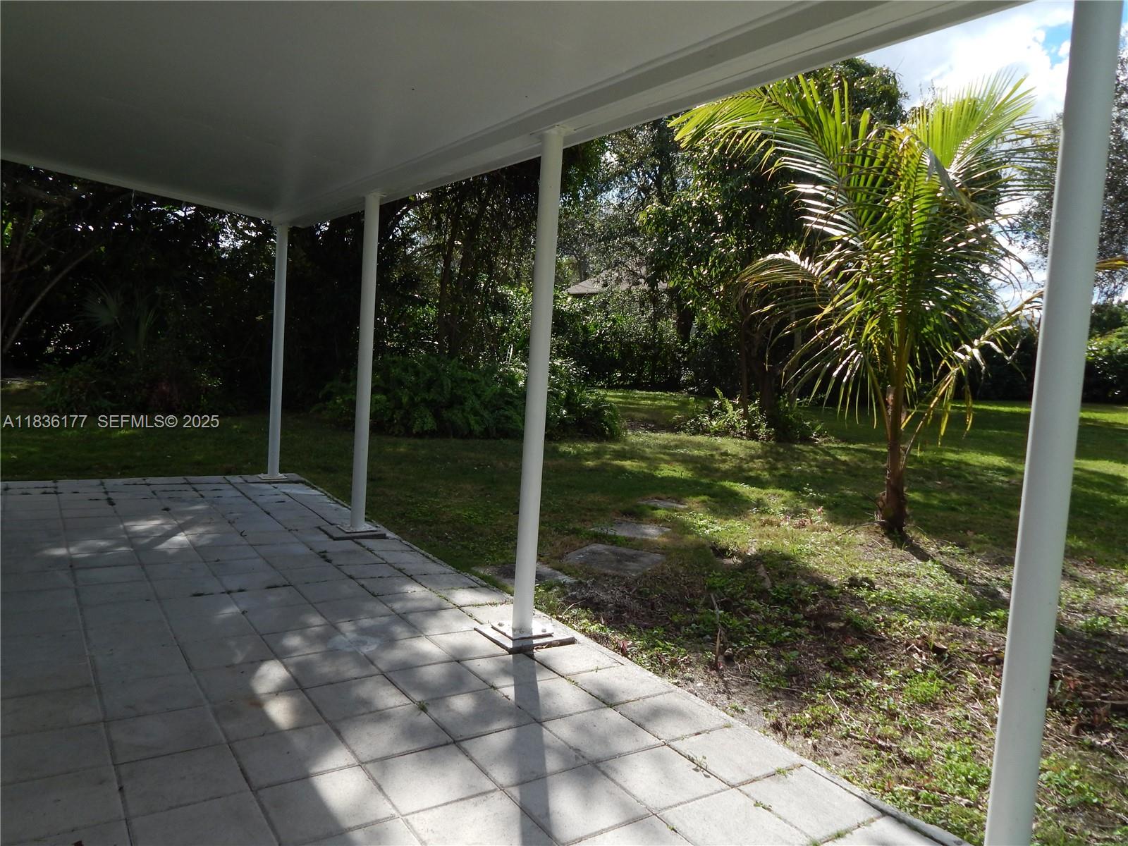 7800 Southwest 69th Avenue Miami, FL 33143 - Photo 18 of 24 a backyard of a house with lots of green space and plants