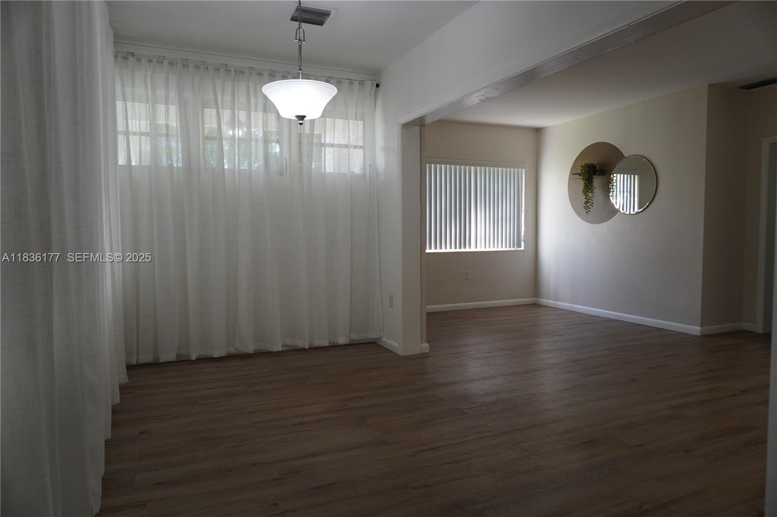 7800 Southwest 69th Avenue Miami, FL 33143 - Photo 3 of 24 an empty room with wooden floor and windows