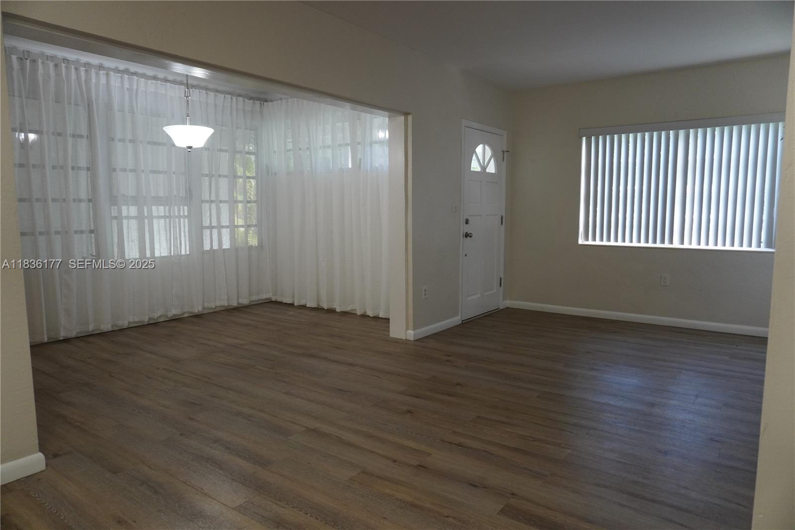7800 Southwest 69th Avenue Miami, FL 33143 - Photo 4 of 24 an empty room with wooden floor and windows