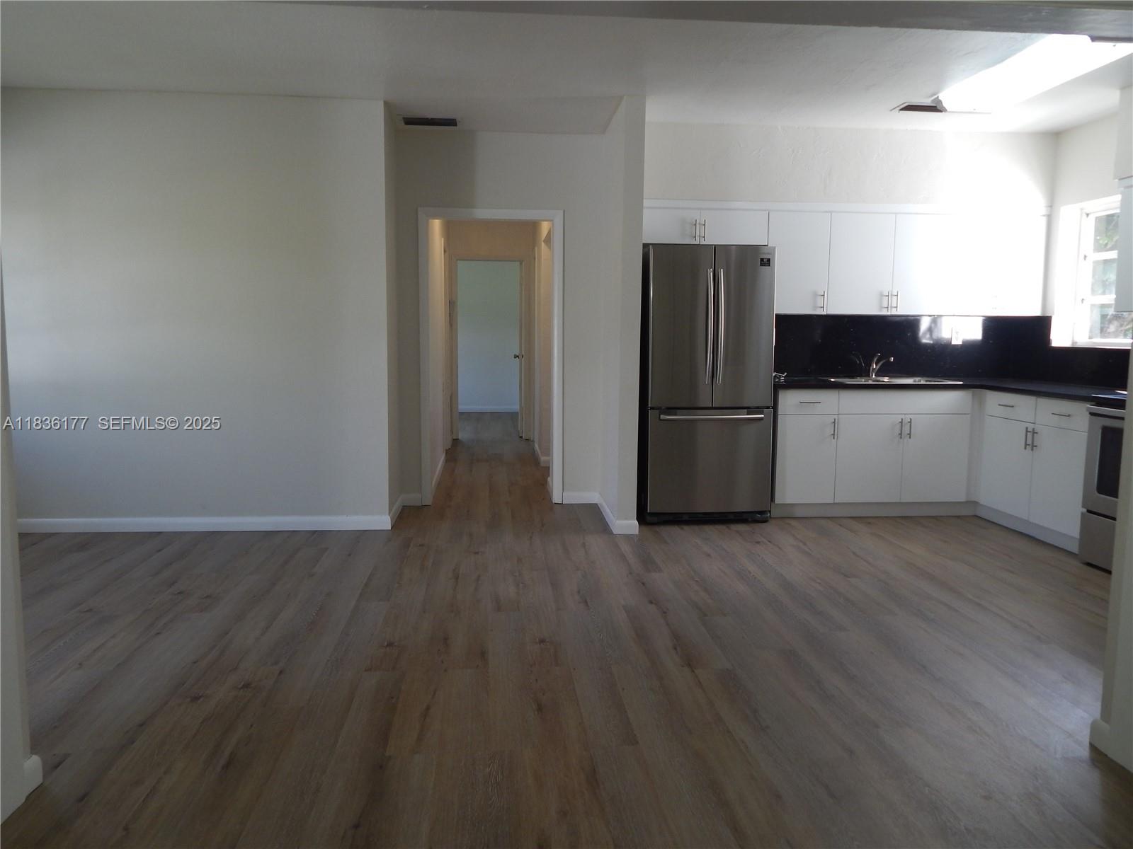 7800 Southwest 69th Avenue Miami, FL 33143 - Photo 7 of 24 a kitchen with a refrigerator and a sink