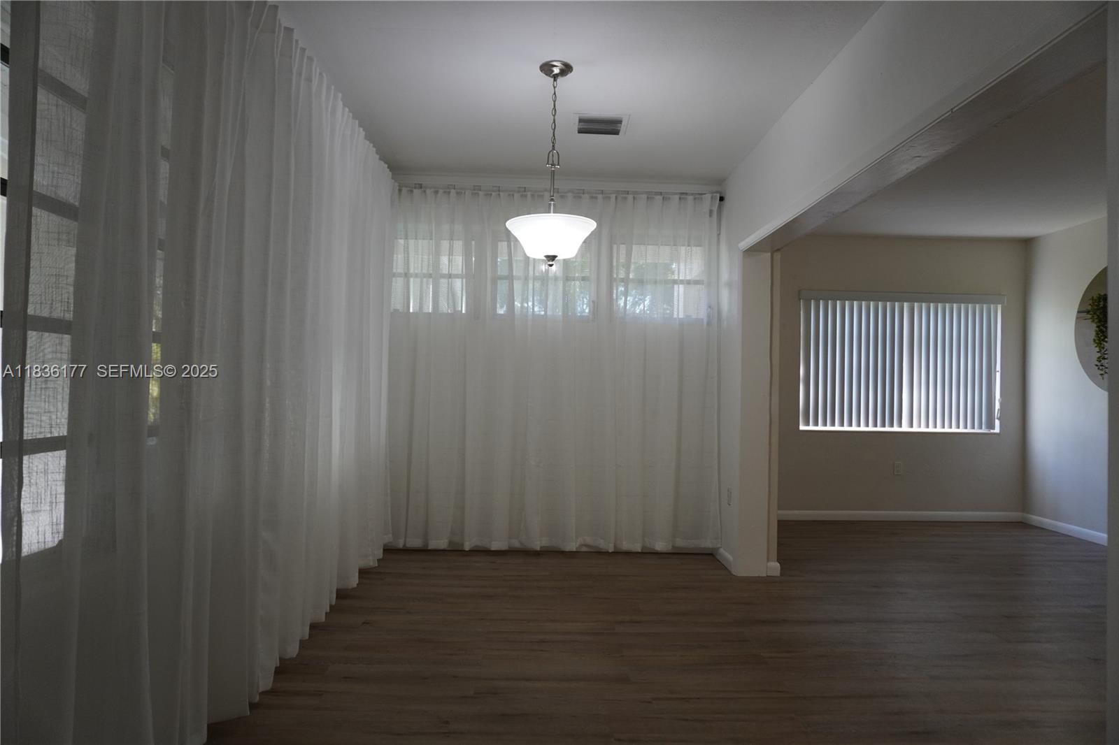 7800 Southwest 69th Avenue Miami, FL 33143 - Photo 8 of 24 a view of an empty room with wooden floor and a window
