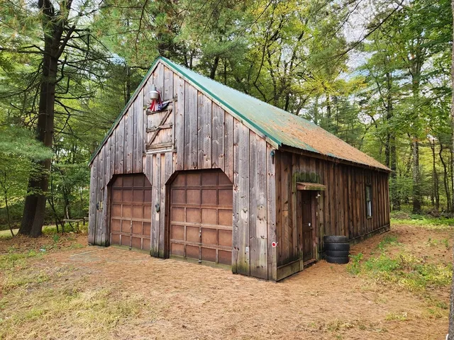 a view of a house with a yard and wooden fence