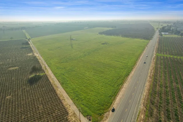 a view of a field with an ocean view