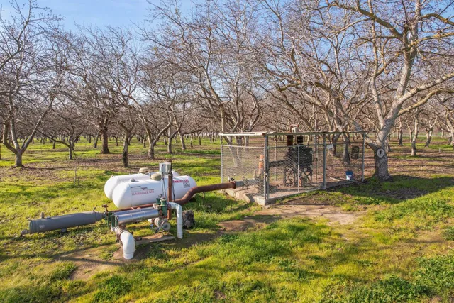 a view of a house with backyard and wooden fence