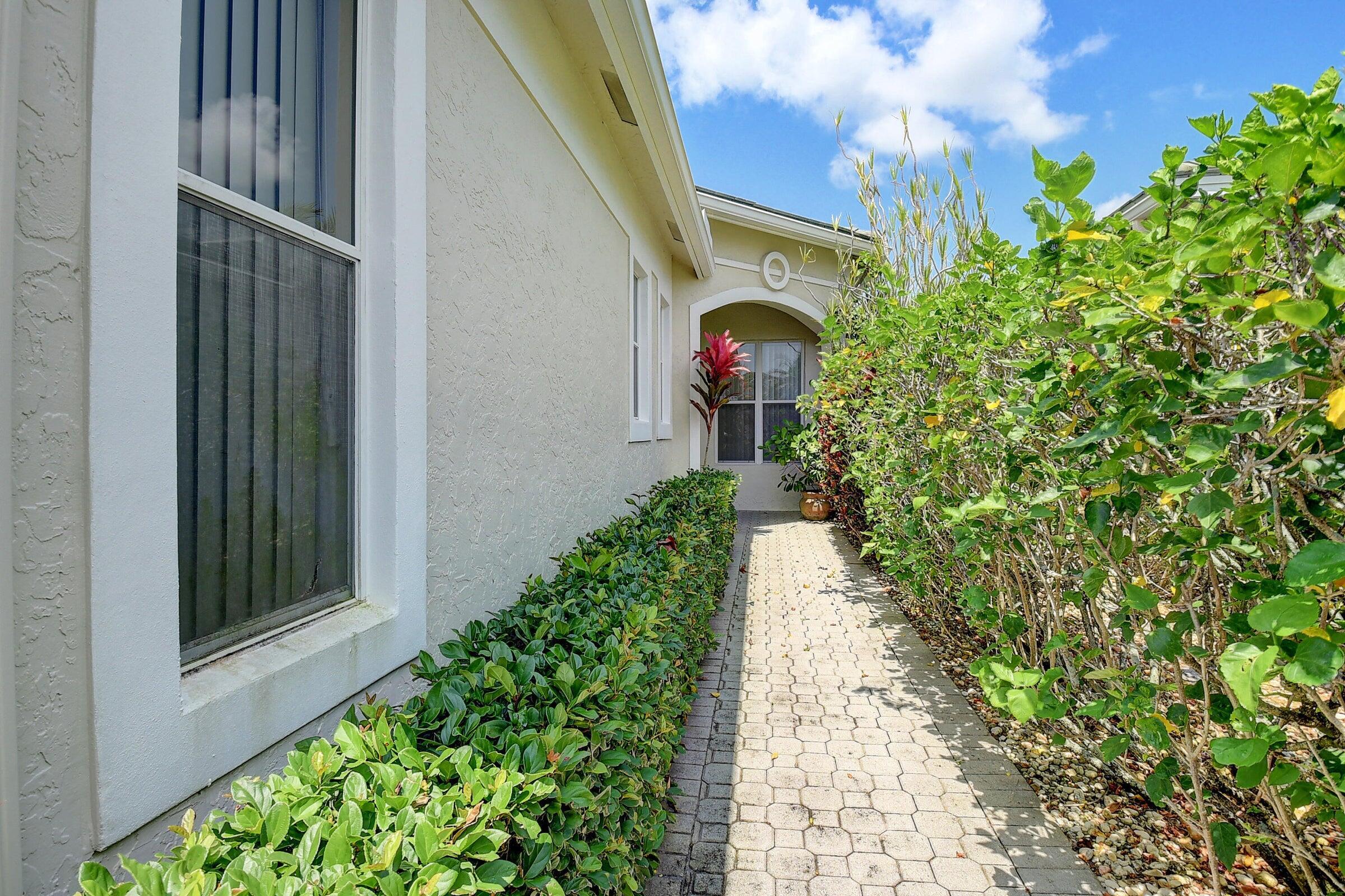 7725 Rockford Road Boynton Beach, FL 33472 - Photo 2 of 47 a path view of a house with a yard
