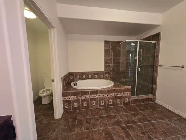 a bathroom with a toilet and a shower