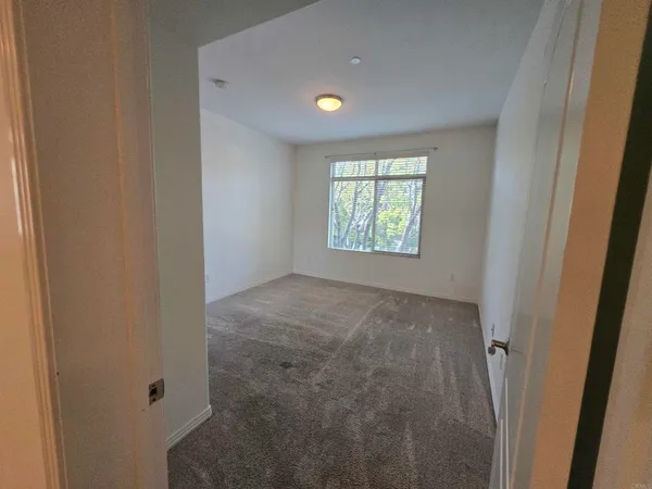 a view of an empty room and a window