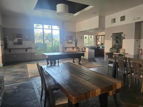 a living room with furniture a fireplace and a floor to ceiling window