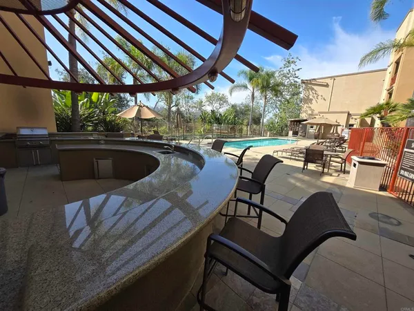 a view of a patio with table and chairs and potted plants