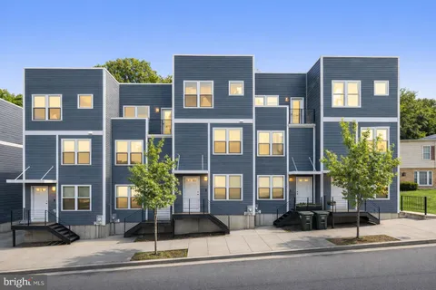a kitchen with a stove top oven a refrigerator and a sink