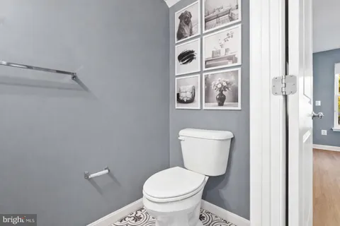 a bathroom with a sink a mirror and toilet