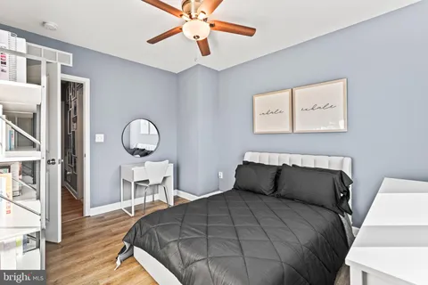 a bedroom with a bed and wooden floor