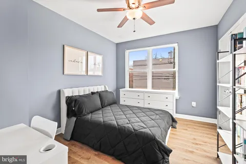 a bedroom with a bed a bookshelf and a bookshelf