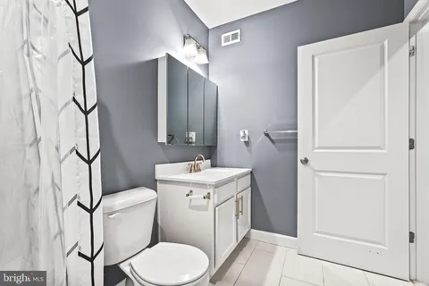 a view of bathroom with toilet and a window