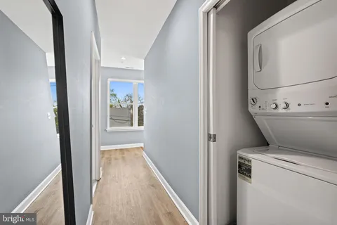 a view of a hallway with wooden floor and entryway