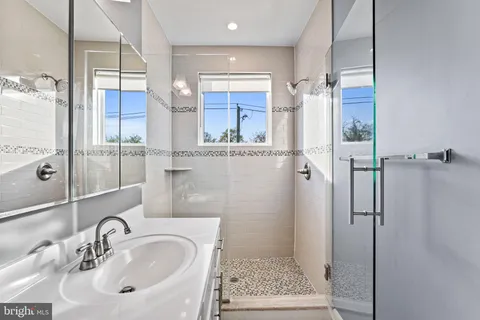 a bathroom with a toilet sink shower and mirror