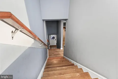 a view of a house with a small yard and wooden floor and fence