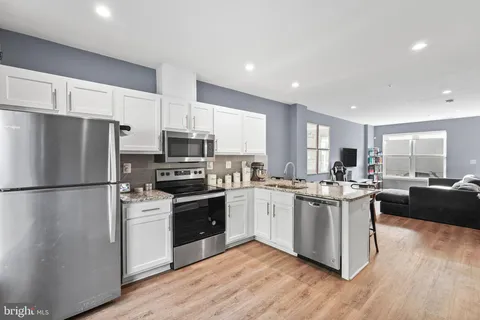 a living room with furniture a large window and a table