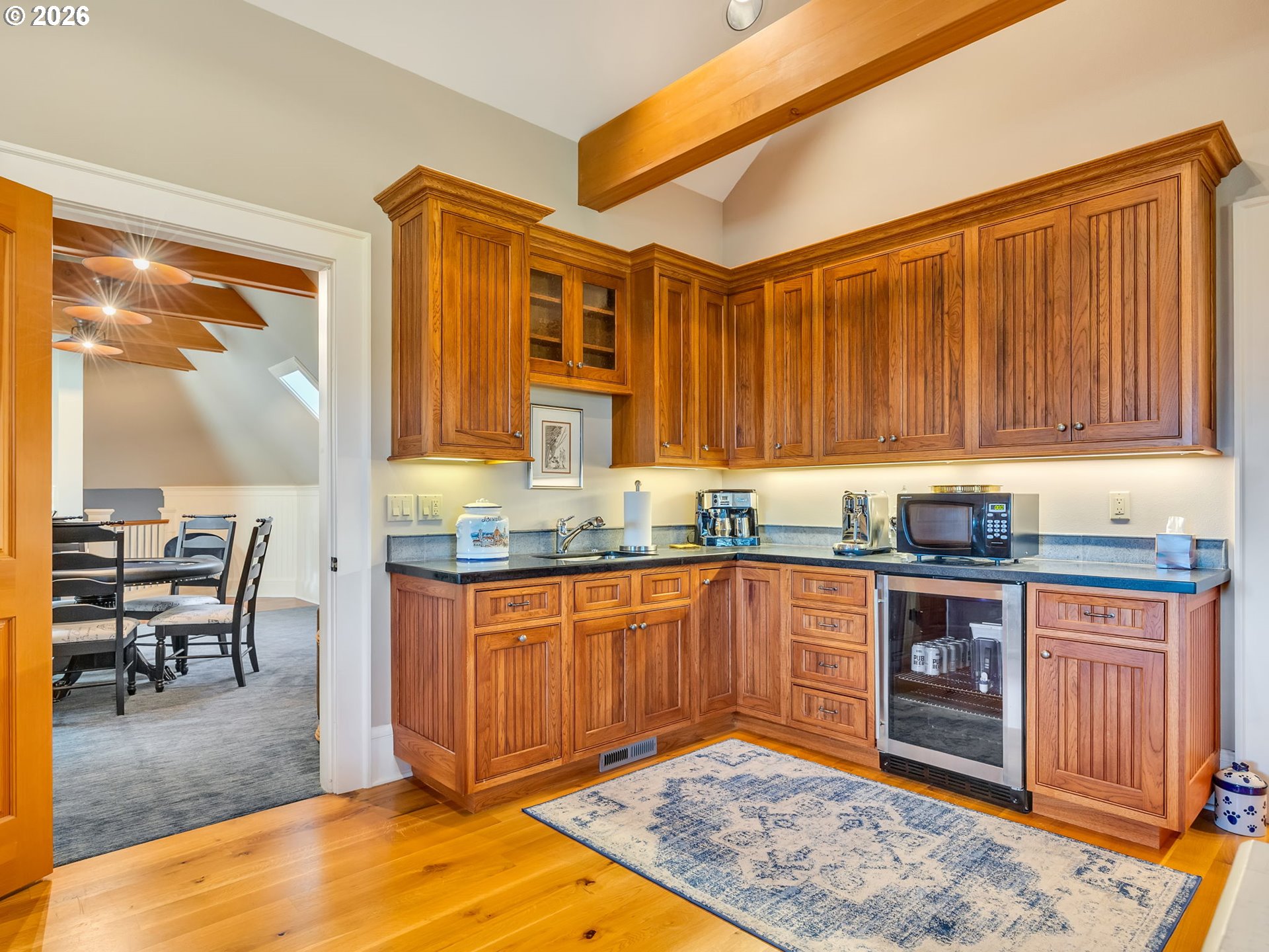 89079 Pinehurst Road Warrenton, OR 97146 - Photo 39 of 46 a kitchen with stainless steel appliances granite countertop wooden cabinets a dining table and chairs
