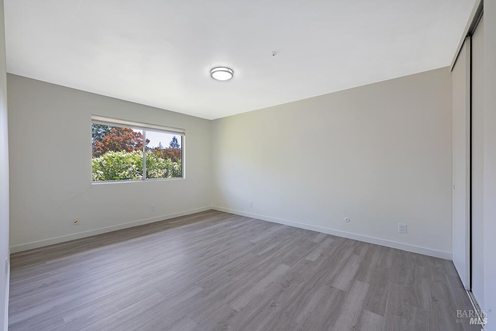 1155-1175 Evans Drive Santa Rosa, CA 95405 - Photo 26 of 31 a view of an empty room with wooden floor and a window