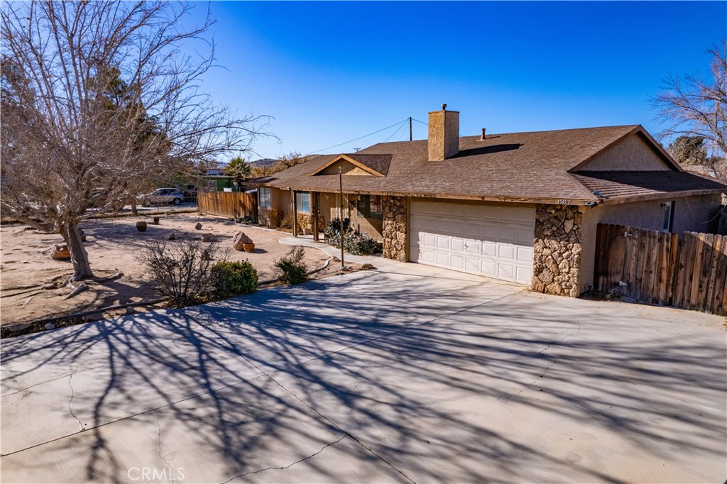 15482 Apache Road Apple Valley, CA 92307 - Photo 1 of 1 a front view of a house with trees