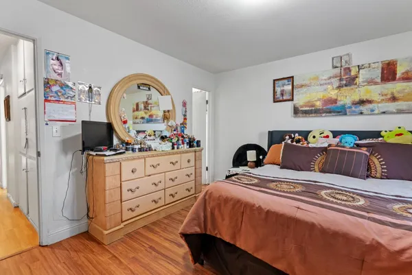 a bedroom with a bed and a dresser in it