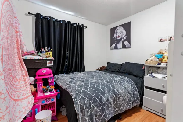 a bedroom with a bed and a dresser in it