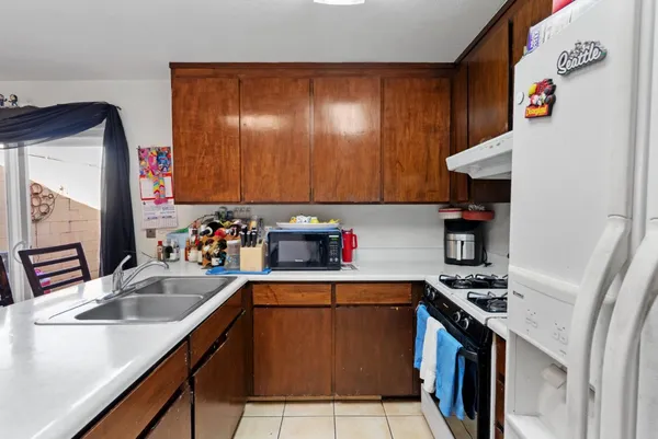 a kitchen that has a sink and a stove