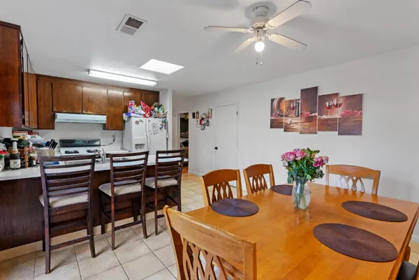 a dinning room with furniture and a kitchen view
