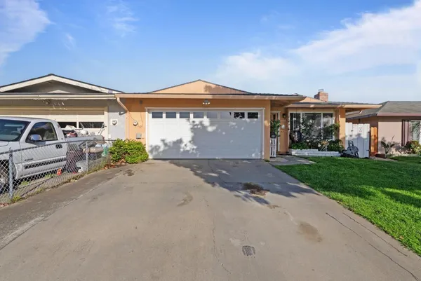 a front view of a house with a garden and yard