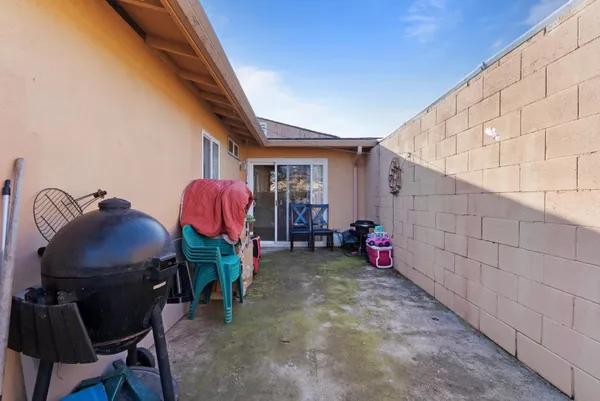 a view of backyard with parked cars