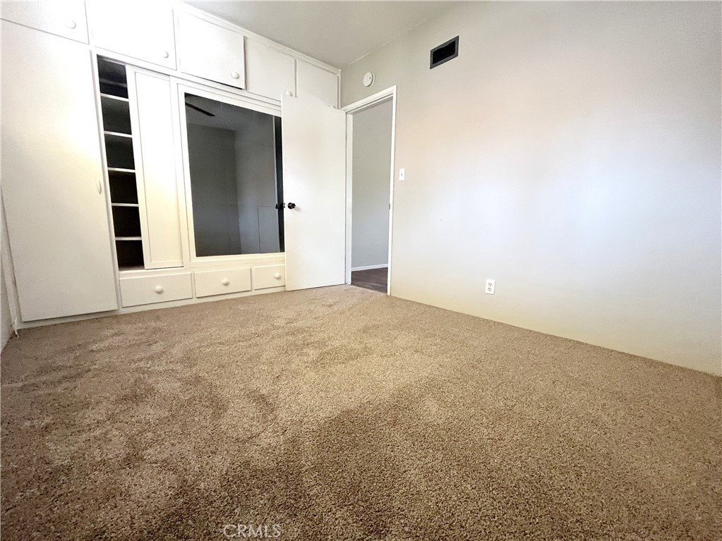 10 West Cypress Avenue Redlands, CA 92373 - Photo 10 of 11 a view of an empty room with cabinet and mirrors